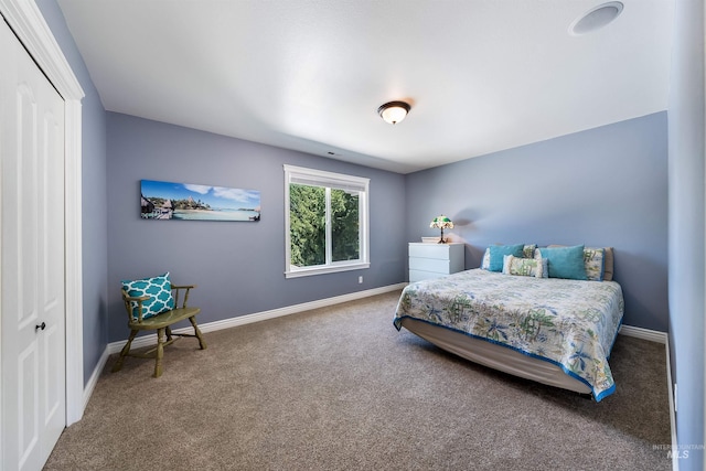 bedroom with a closet, baseboards, and carpet flooring