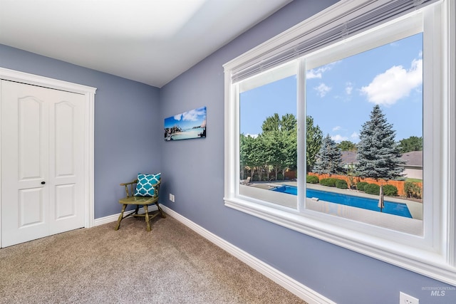 sitting room featuring carpet and baseboards