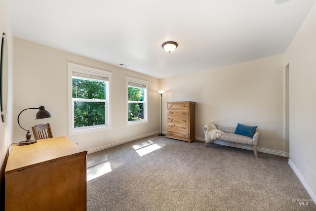 unfurnished room with carpet flooring, visible vents, and baseboards