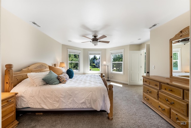 bedroom featuring visible vents, ceiling fan, light carpet, and baseboards