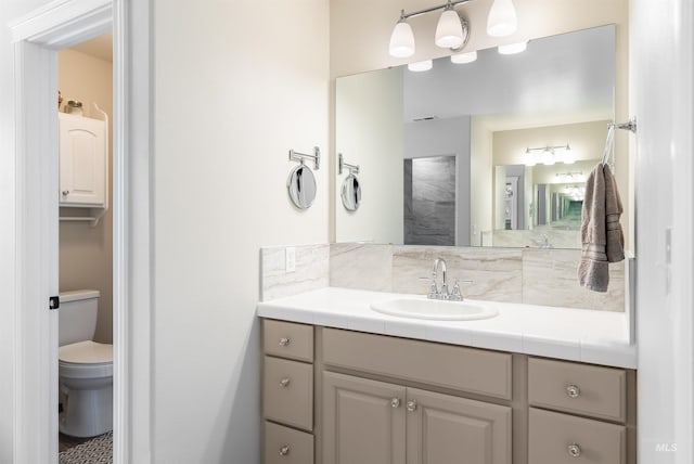 bathroom featuring toilet and vanity