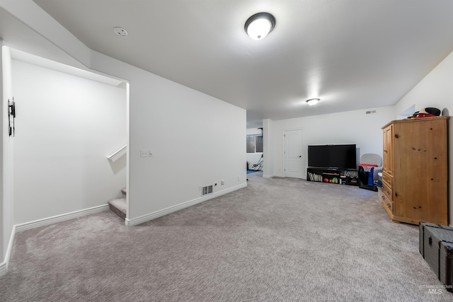 unfurnished living room featuring carpet floors, stairway, visible vents, and baseboards