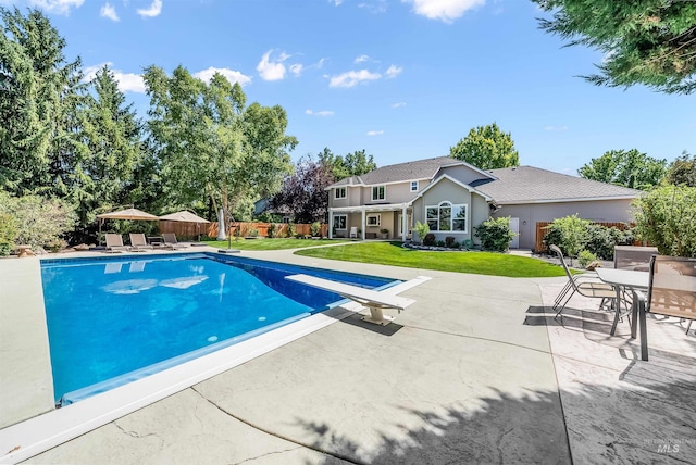 view of pool featuring a fenced in pool, fence, a lawn, and a patio