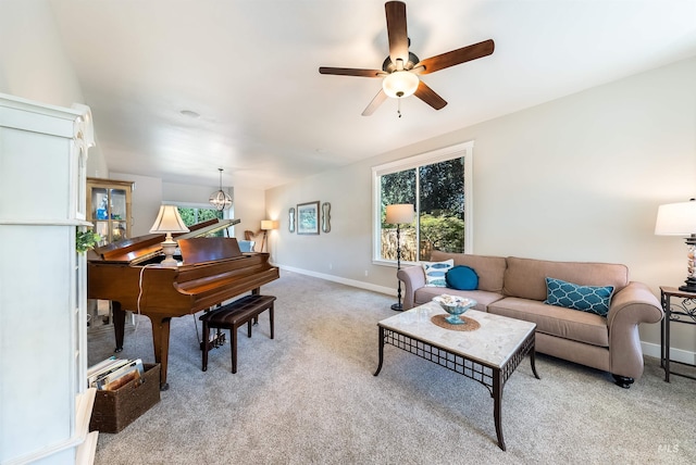 living room featuring light colored carpet, ceiling fan, and baseboards