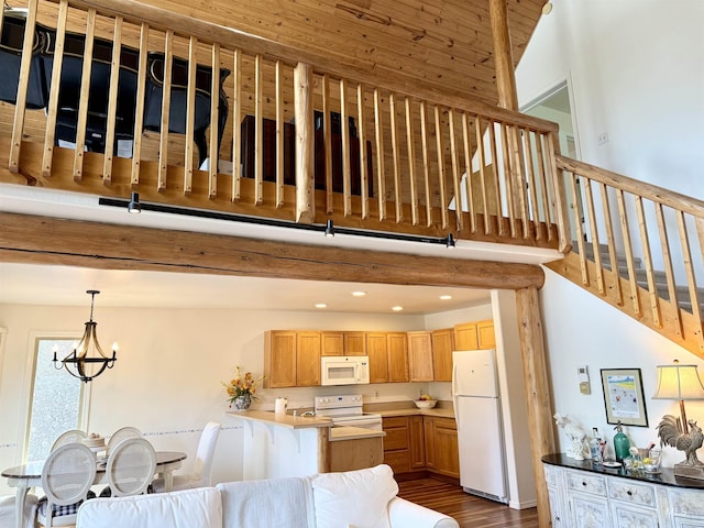 1425 Clements, Mccall, ID 83638 - kitchen featuring white appliances, dark wood-style flooring, a peninsula, recessed lighting, and a chandelier