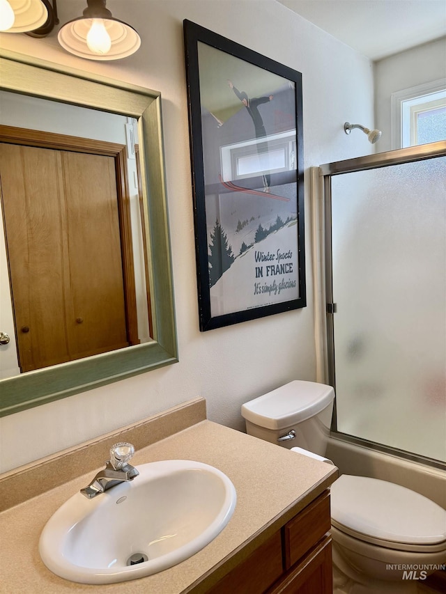 1425 Clements, Mccall, ID 83638 - full bathroom with vanity, toilet, and enclosed tub / shower combo