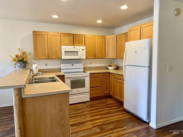 1425 Clements, Mccall, ID 83638 - kitchen featuring white appliances, a sink, a peninsula, dark wood-type flooring, and light countertops
