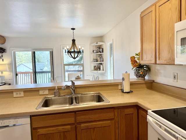 1425 Clements, Mccall, ID 83638 - kitchen featuring a sink, white appliances, light countertops, and hanging light fixtures