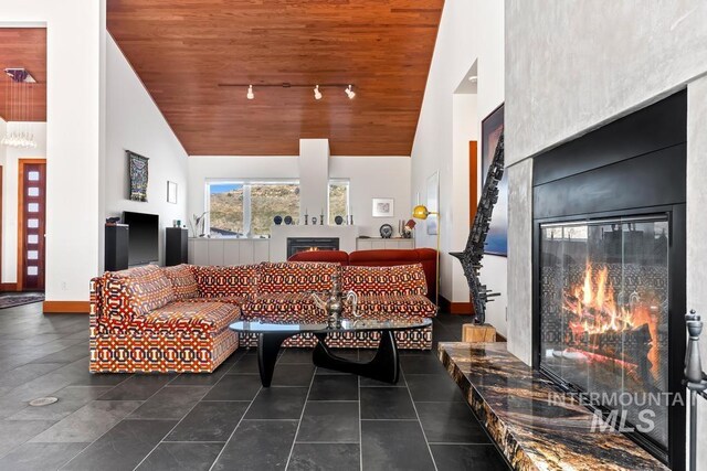 4336 N Star Vista Ln, Eagle, ID 83616 - living room featuring a glass covered fireplace, high vaulted ceiling, wooden ceiling, baseboards, and track lighting