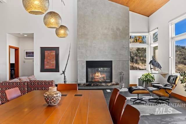 4336 N Star Vista Ln, Eagle, ID 83616 - dining space with high vaulted ceiling, a tile fireplace, baseboards, and wood ceiling