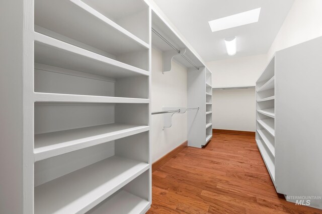 4336 N Star Vista Ln, Eagle, ID 83616 - walk in closet featuring a skylight and wood finished floors