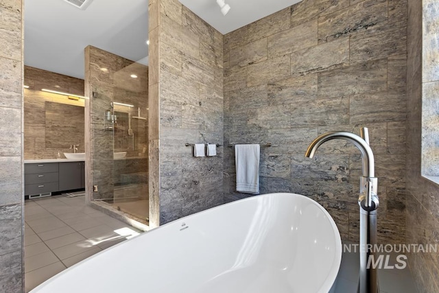 4336 N Star Vista Ln, Eagle, ID 83616 - bathroom featuring tile walls, vanity, a stall shower, a soaking tub, and tile patterned flooring