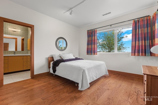 4336 N Star Vista Ln, Eagle, ID 83616 - bedroom featuring track lighting, light wood-style floors, and baseboards