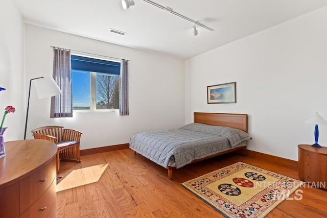 4336 N Star Vista Ln, Eagle, ID 83616 - bedroom featuring track lighting, light wood-style flooring, and baseboards