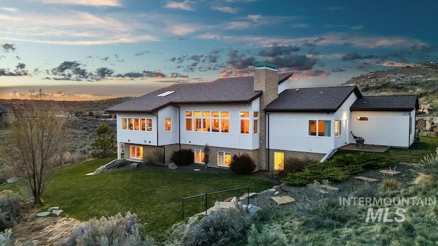 4336 N Star Vista Ln, Eagle, ID 83616 - back of property featuring a lawn, a chimney, and a shingled roof