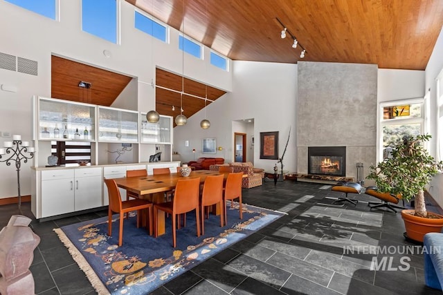 4336 N Star Vista Ln, Eagle, ID 83616 - dining room featuring a towering ceiling, wooden ceiling, healthy amount of natural light, and a large fireplace