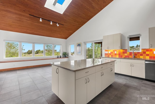 4336 N Star Vista Ln, Eagle, ID 83616 - kitchen featuring rail lighting, stainless steel dishwasher, a sink, a skylight, and a center island