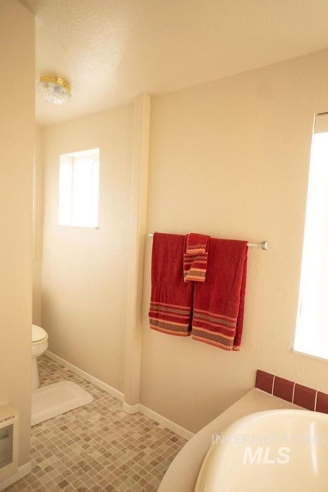 bathroom with tile patterned flooring and toilet