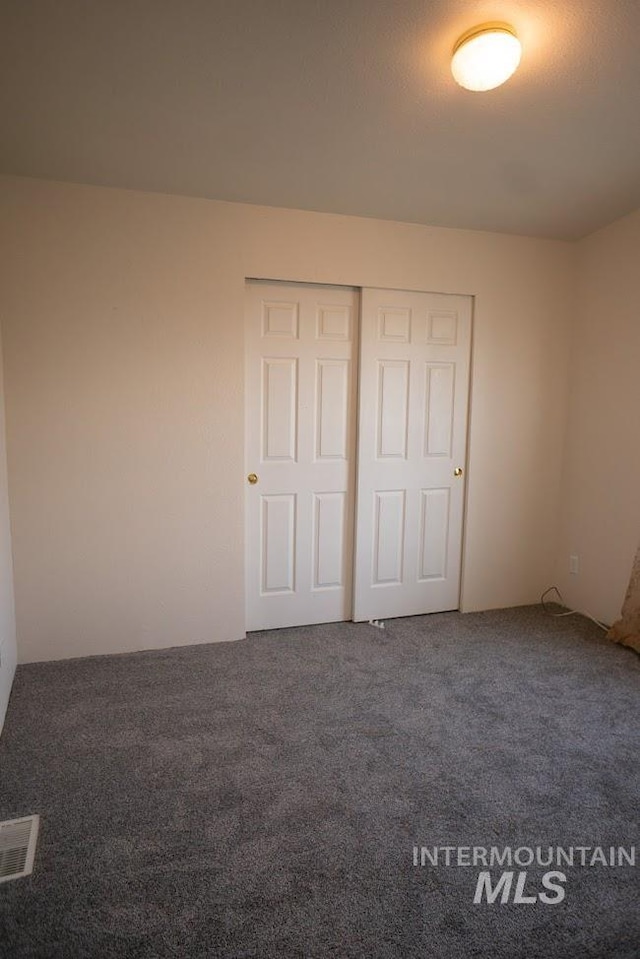 unfurnished bedroom featuring a closet and carpet floors