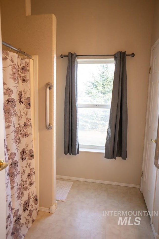 bathroom featuring tile patterned floors and a healthy amount of sunlight