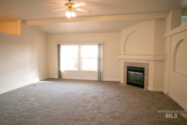 unfurnished living room featuring a fireplace, carpet flooring, ceiling fan, and lofted ceiling with beams