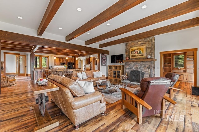 1418 Club Hill Blvd, Mccall, ID 83638 - living room featuring a stone fireplace, beamed ceiling, wood finished floors, and recessed lighting