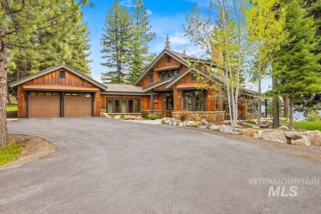 1418 Club Hill Blvd, Mccall, ID 83638 - chalet / cabin featuring a garage and asphalt driveway