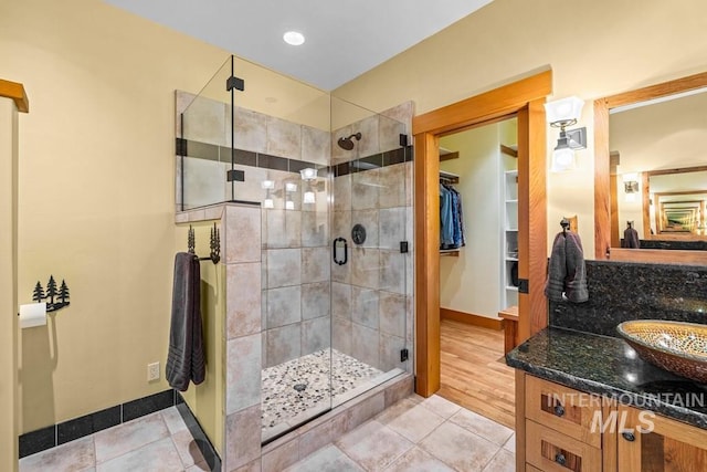 1418 Club Hill Blvd, Mccall, ID 83638 - full bathroom featuring a shower stall, vanity, baseboards, and tile patterned flooring