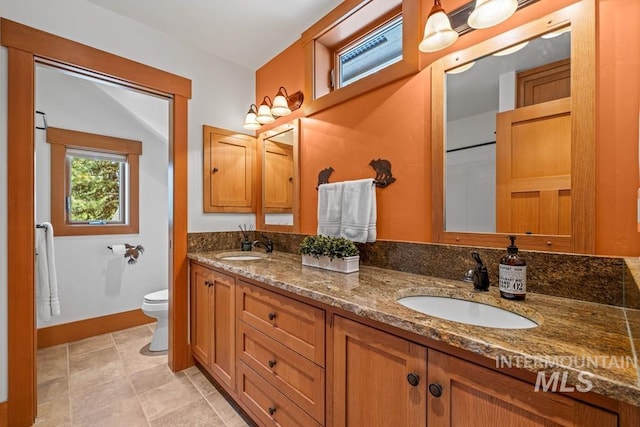 1418 Club Hill Blvd, Mccall, ID 83638 - bathroom with toilet, double vanity, and baseboards