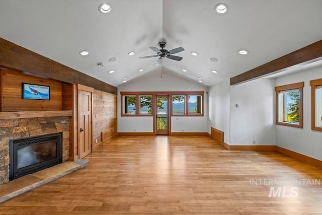 1418 Club Hill Blvd, Mccall, ID 83638 - unfurnished living room featuring a stone fireplace, lofted ceiling, light wood finished floors, baseboards, and a ceiling fan