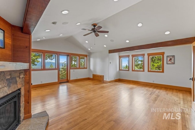 1418 Club Hill Blvd, Mccall, ID 83638 - unfurnished living room featuring a glass covered fireplace, ceiling fan, baseboards, lofted ceiling, and light wood finished floors