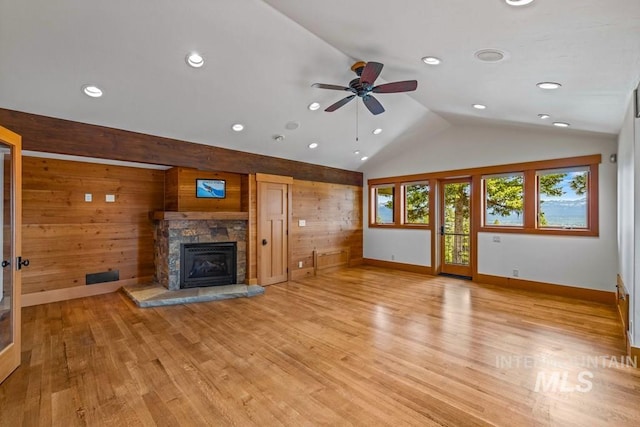 1418 Club Hill Blvd, Mccall, ID 83638 - unfurnished living room featuring lofted ceiling, wooden walls, a fireplace, baseboards, and ceiling fan