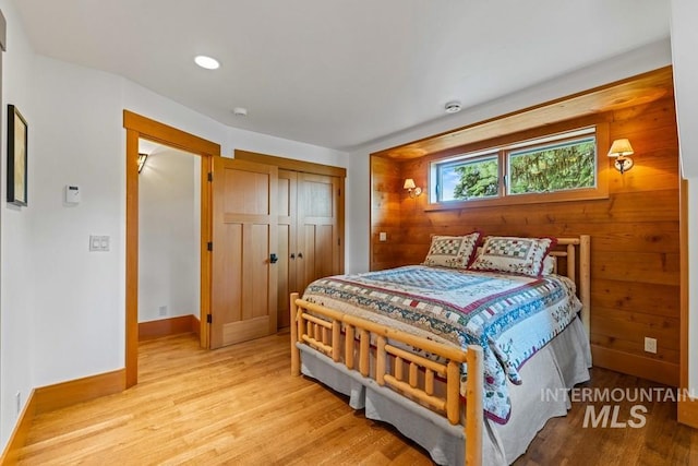 1418 Club Hill Blvd, Mccall, ID 83638 - bedroom with light wood-style floors, baseboards, a closet, wood walls, and recessed lighting