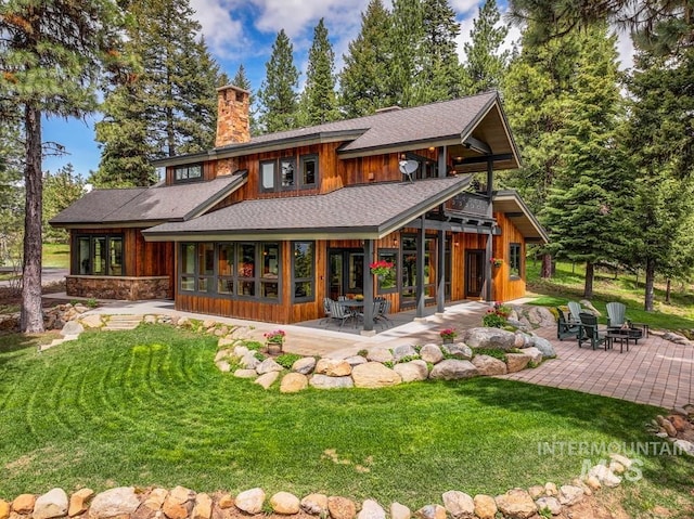 1418 Club Hill Blvd, Mccall, ID 83638 - back of house with a patio area, a chimney, an outdoor fire pit, and a lawn