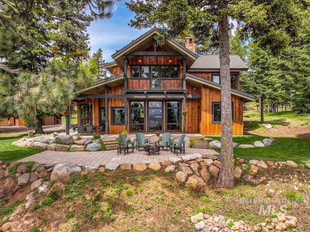 1418 Club Hill Blvd, Mccall, ID 83638 - rear view of property with a chimney, a patio area, a balcony, and a fire pit