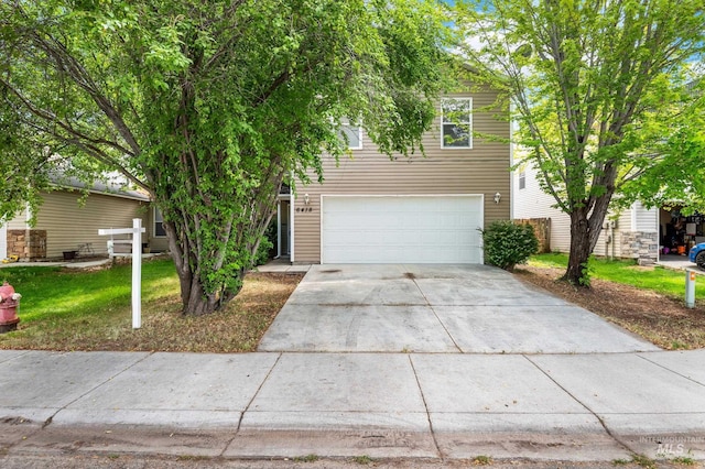 6418 S White Cliff Ave, Boise, ID 83709 - obstructed view of property with a garage, concrete driveway, and a front lawn