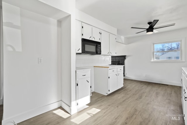 923 13th St S, Nampa, ID 83651 - kitchen featuring black microwave, a ceiling fan, light countertops, and light wood-type flooring