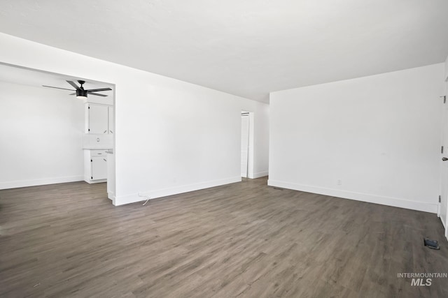 923 13th St S, Nampa, ID 83651 - unfurnished living room with dark wood finished floors, baseboards, and ceiling fan