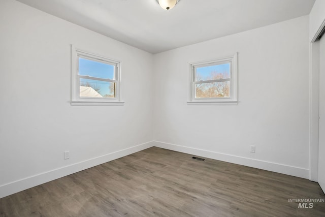 923 13th St S, Nampa, ID 83651 - empty room featuring healthy amount of natural light, baseboards, and wood finished floors