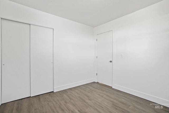 923 13th St S, Nampa, ID 83651 - unfurnished bedroom featuring wood finished floors, baseboards, and a closet