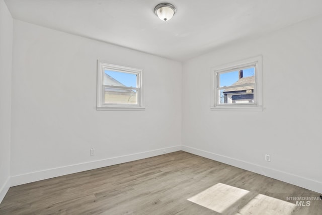 923 13th St S, Nampa, ID 83651 - empty room with healthy amount of natural light, baseboards, and wood finished floors