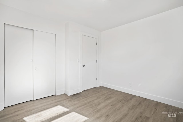 923 13th St S, Nampa, ID 83651 - unfurnished bedroom featuring wood finished floors, baseboards, and a closet