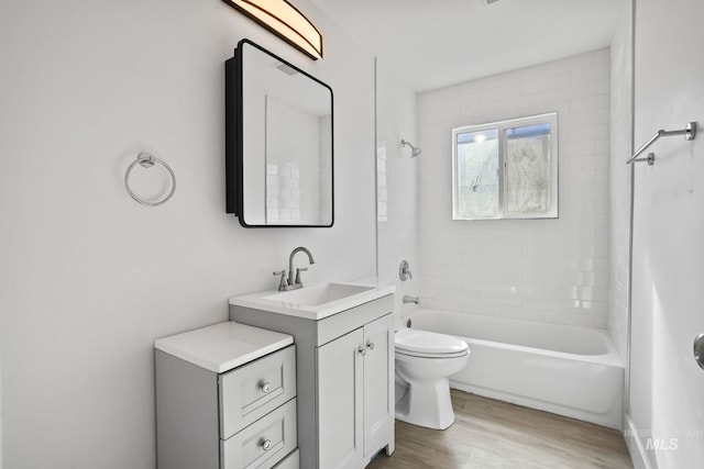 923 13th St S, Nampa, ID 83651 - full bathroom with wood finished floors, toilet, vanity, and bathing tub / shower combination