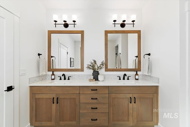 bathroom featuring tasteful backsplash, a sink, and double vanity