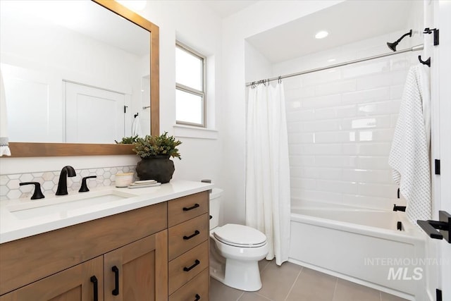 full bathroom with tile patterned flooring, toilet, vanity, decorative backsplash, and shower / bath combo