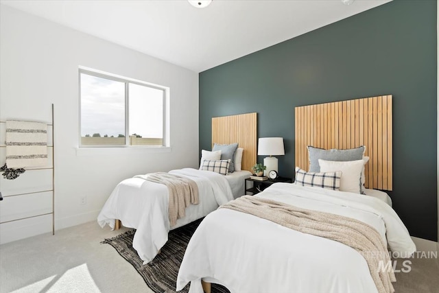 carpeted bedroom featuring baseboards