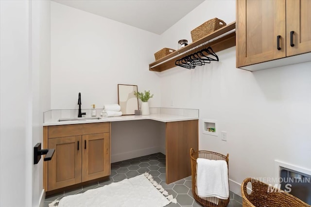 washroom with cabinet space, tile patterned flooring, hookup for a washing machine, and a sink