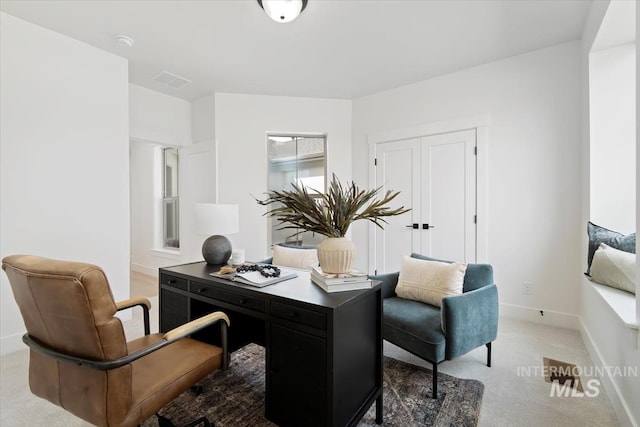 home office featuring light carpet, visible vents, and baseboards