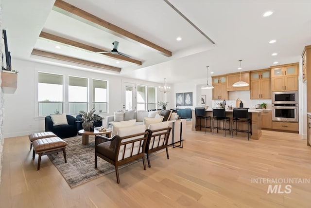 living area with recessed lighting, light wood-style flooring, beam ceiling, and ceiling fan with notable chandelier