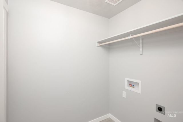 washroom featuring baseboards, hookup for a washing machine, visible vents, hookup for an electric dryer, and laundry area